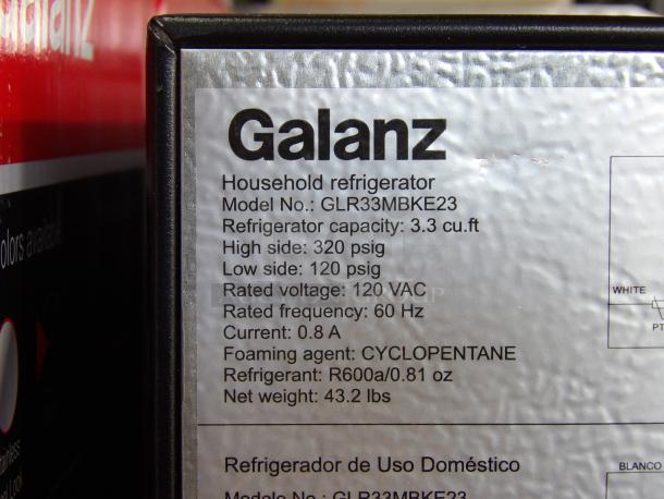 Black Galanz 3.3 cu. ft single door refrigerator, model GLR33MBKE23, new with scratches and dents. Label shows specs.