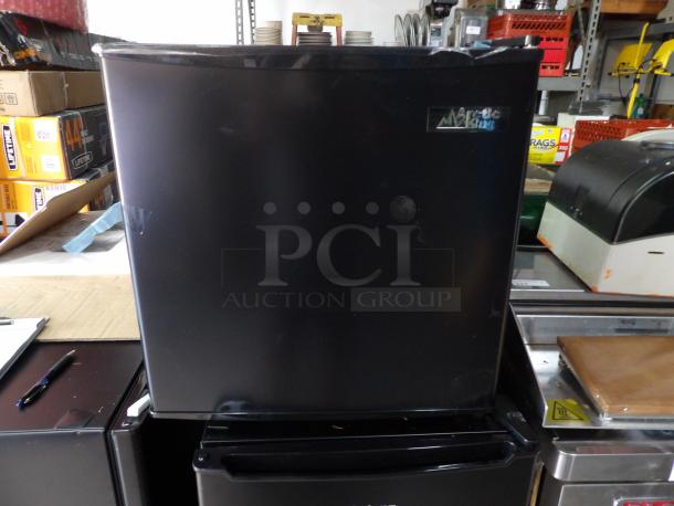 New Artic King black single door refrigerator, scratch & dent, visible tape, brand logo on top right corner.
