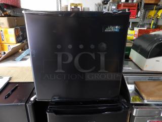 New scratch & dent Artic King black single door refrigerator. Compact size, visible brand logo, minor surface blemishes.