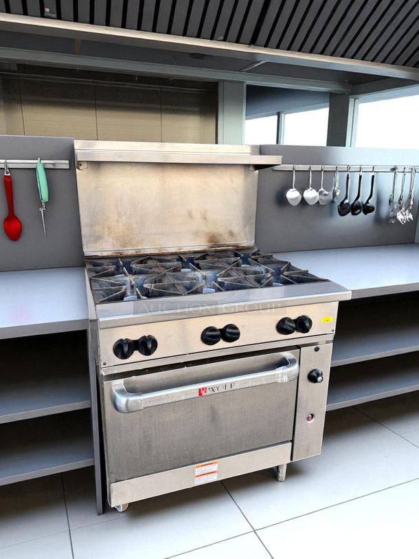 Wolf 36C-Y1R 36" gas range with 6 open burners, natural gas, in excellent condition. Includes standard oven; fully tested.