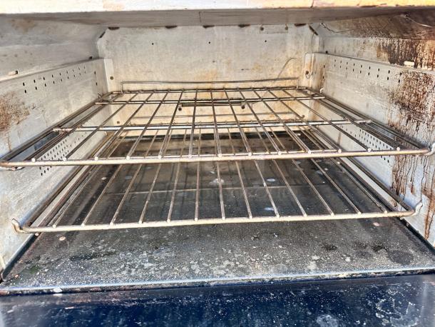Wolf 36C-Y1R gas range oven interior, showing two wire racks and a slightly worn metal surface.