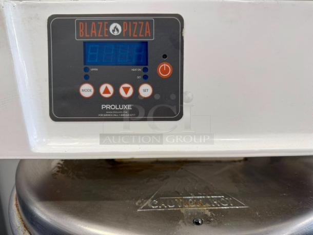 Proluxe DP2350 manual heated pizza dough press with 18" plate in working condition. Control panel and buttons visible.