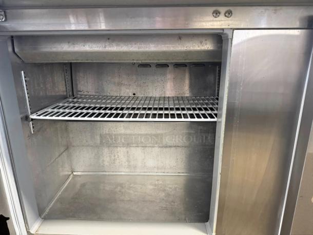 Continental SW60-24M commercial refrigerator freezer, dual lid top access, excellent condition, 115V, interior view.