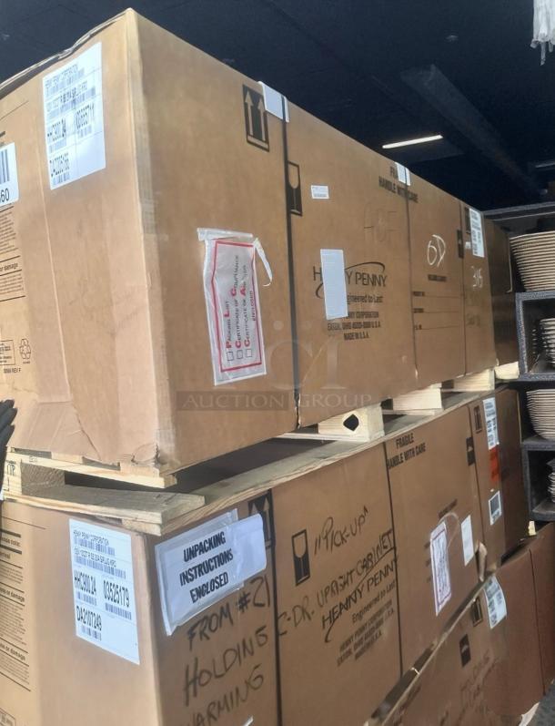 Brand new Henny Penny HHC900.24 electric holding cabinet in box, stainless steel, 2-door, 120V, with original packaging and labels.