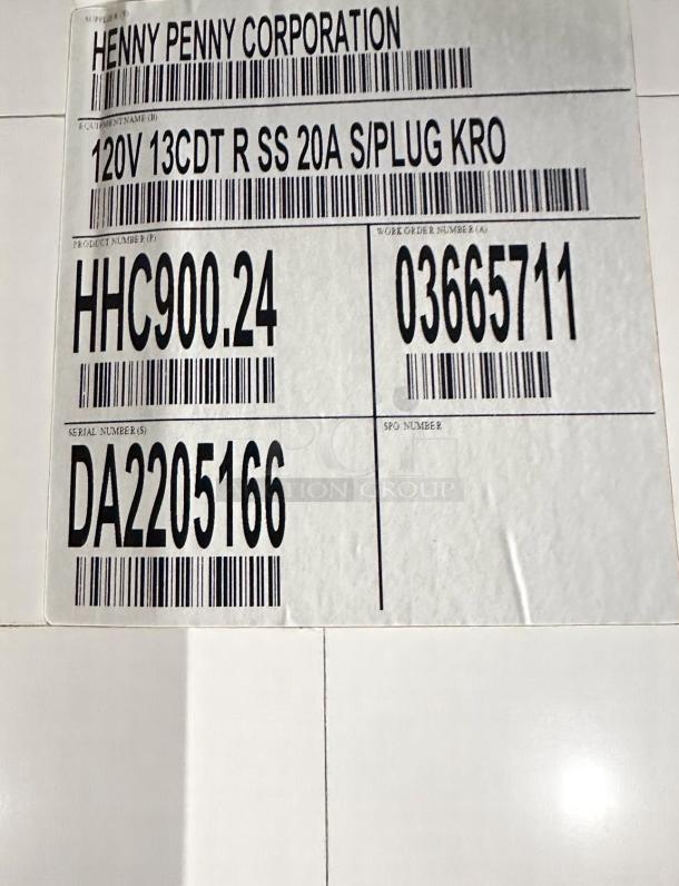 Brand new Henny Penny HHC900.24 electric holding cabinet label, showing model, serial, and voltage details.