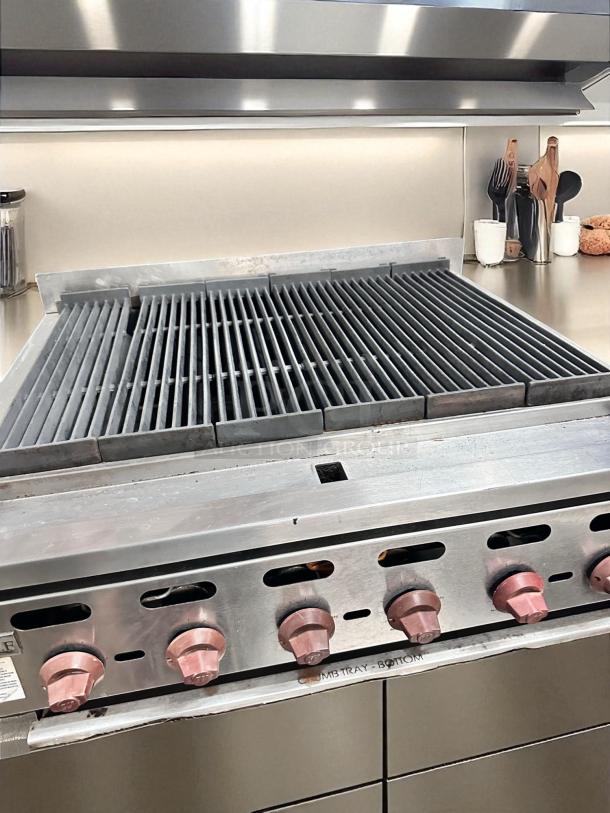 Wolf Range Co. 6-burner gas charbroiler in great condition, fully tested and working. Features natural gas setup, sturdy knobs.