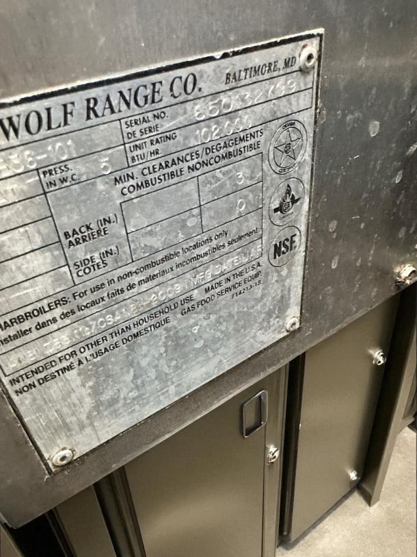 Wolf Range Co. gas charbroiler label, serial no. 85032799, 102,000 BTU/hr, for commercial use, NSF certified, in good condition.