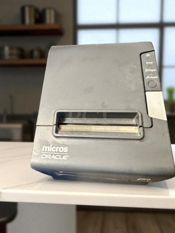 Oracle Micros RES 3700 POS system, gray, front view, with logo and operational buttons visible, in top-tier condition.