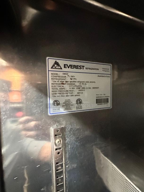 Alt text: Everest EBR2D label on commercial reach-in refrigerator, showing model, compressor, and electrical specs.