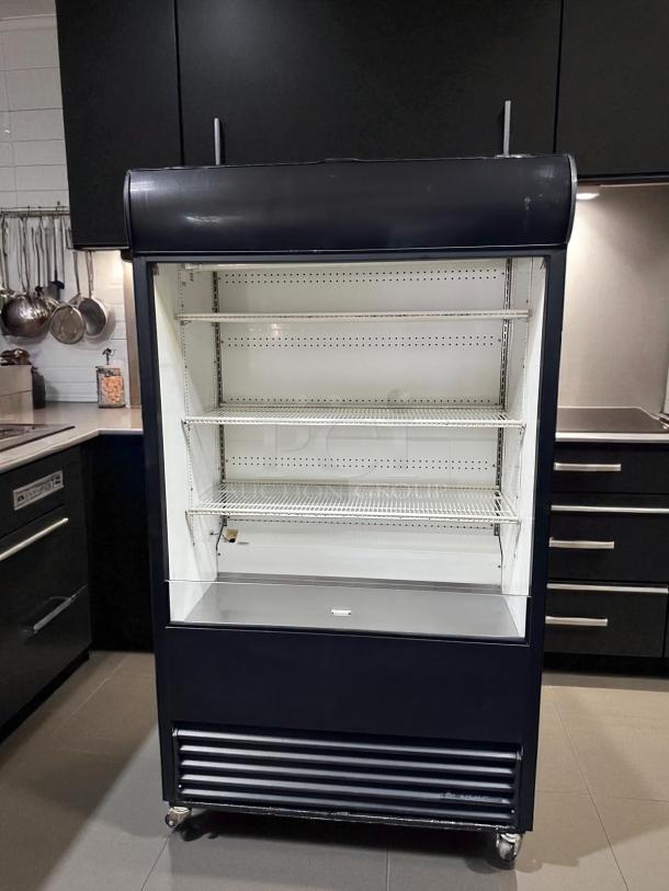 True TAC-48 48" air curtain merchandiser, outstanding condition, black exterior, multiple shelves, on wheels, fully tested.