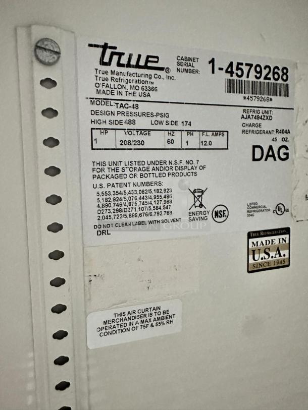True TAC-48 air curtain display merchandiser label; 208/230V, model TAC-48, made in USA, NSF certified, in outstanding condition.