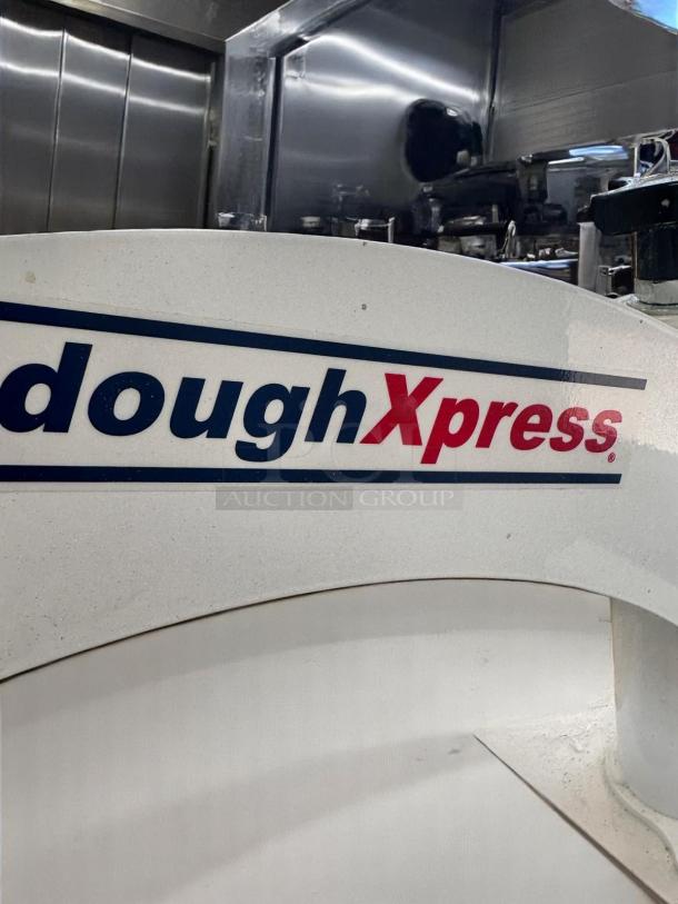 Superb condition DoughXpress DM-18 manual dough press, 18" plate, heavy-duty steel, fully tested, with logo visible.