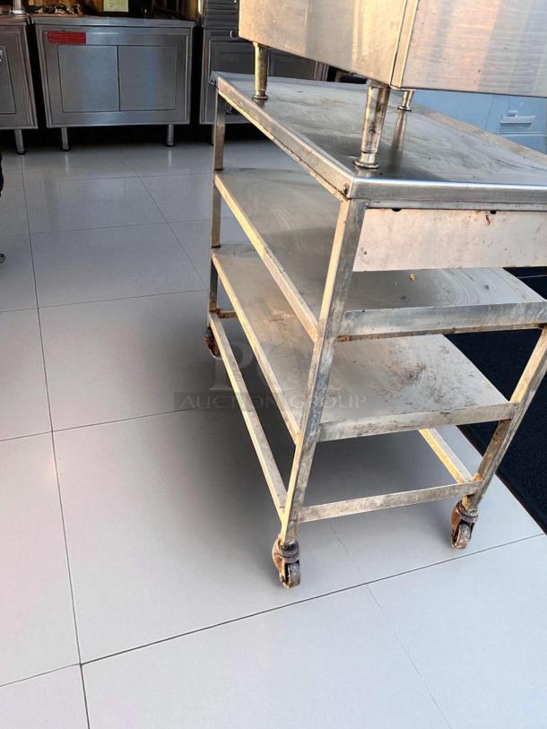 Stainless steel 3-tier prep table on casters, 18"x36"x34.5", superb condition, cleaned and tested, ideal for commercial use.