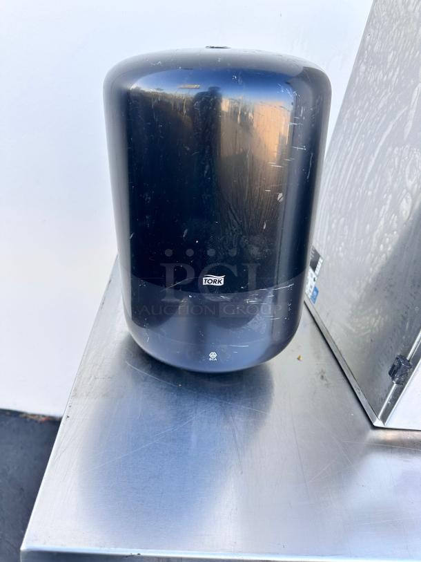 Tork H2 black paper towel dispenser, wall-mountable, commercial grade, superb condition, tested and functional.