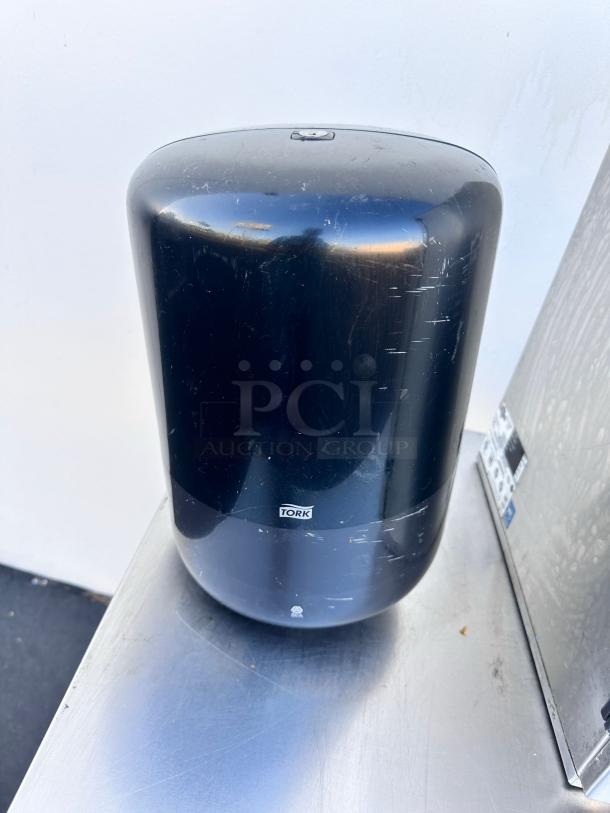 Tork H2 black paper towel dispenser, wall-mountable, commercial grade, superb condition, visible logo.
