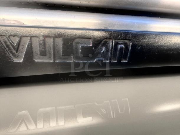 Vulcan logo on a gas range, model V36. Black embossed lettering, indicating brand authenticity.