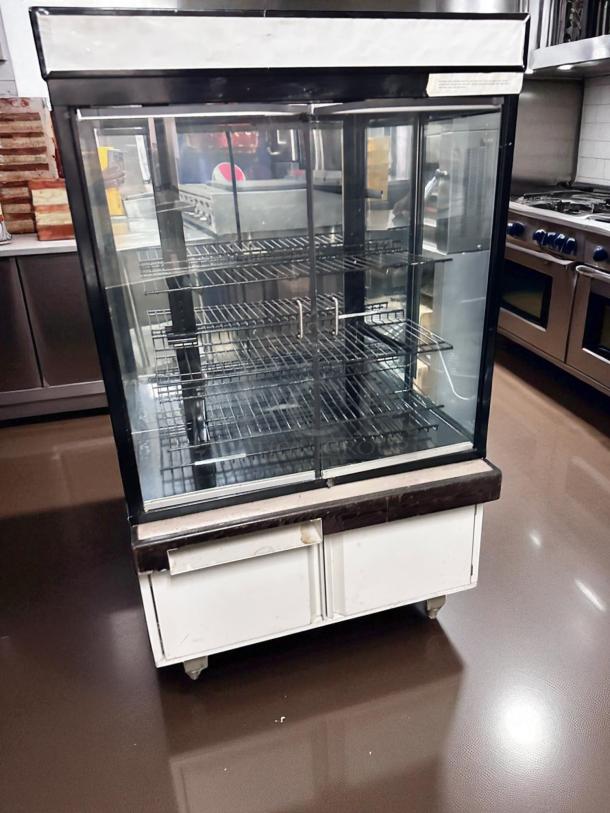 Pristine Hussmann DCB-243662 refrigerated merchandiser, 36" display case, 115V, fully tested, excellent condition, with glass doors.