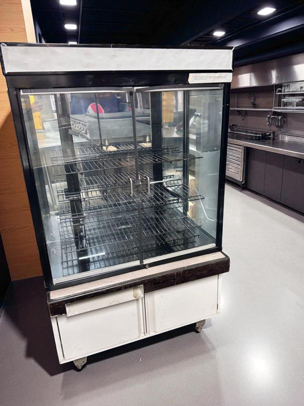 Hussmann DCB-243662 refrigerated merchandiser in pristine condition, 36" display case, 115V, fully tested and cooling, with glass doors.