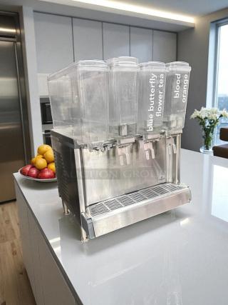 Crathco CS-4E-2 cold beverage dispenser with four 5-gallon bowls, excellent condition. Labels: blue butterfly flower tea, blood orange.