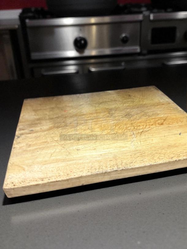 Heavy-duty wood butcher block cutting board, thick and commercial grade, in solid condition, cleaned and ready to use.