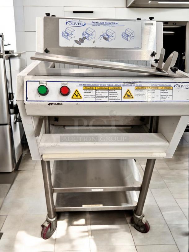 Oliver Bread Slicer Model 624, 115V, front load, fully tested, excellent condition. Features start/stop buttons, safety warnings.