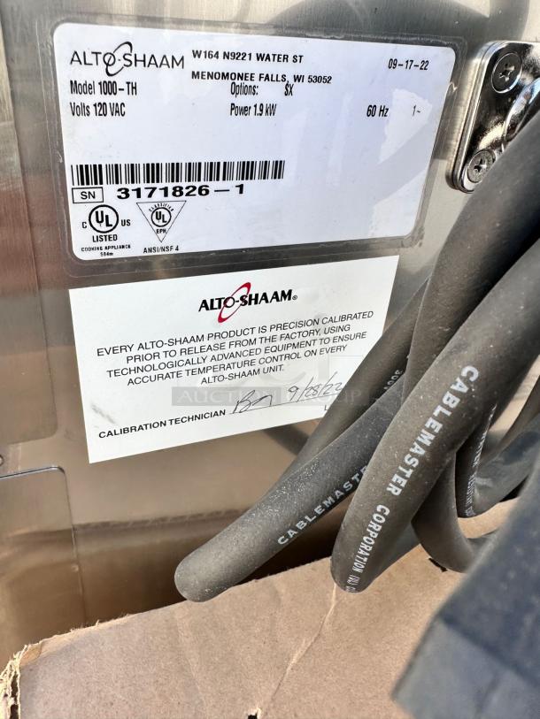 Brand new Alto-Shaam 1000-TH low-temp cook & hold oven, 120V, factory sealed. Label shows specifications and calibration info.