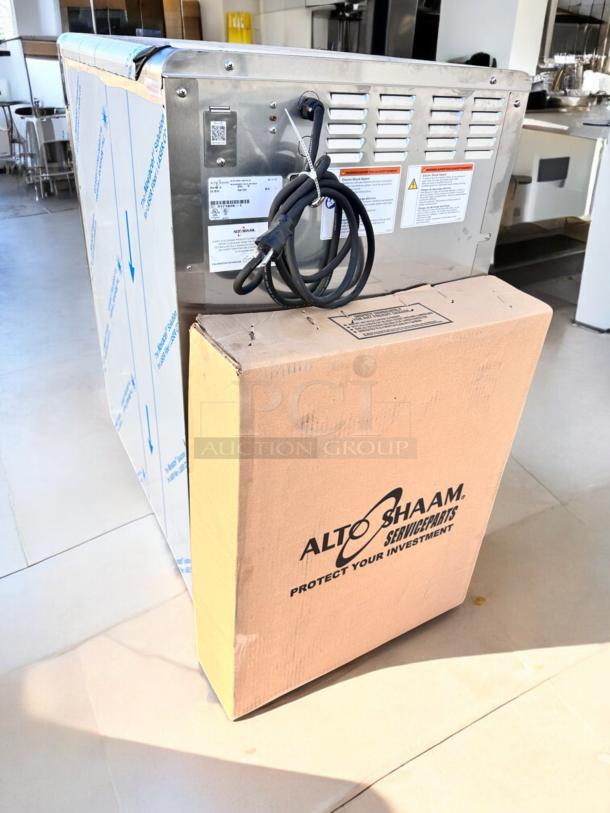 Brand new Alto-Shaam 1000-TH oven, low-temp cook & hold, 120V, factory sealed in box, visible cord and labels.