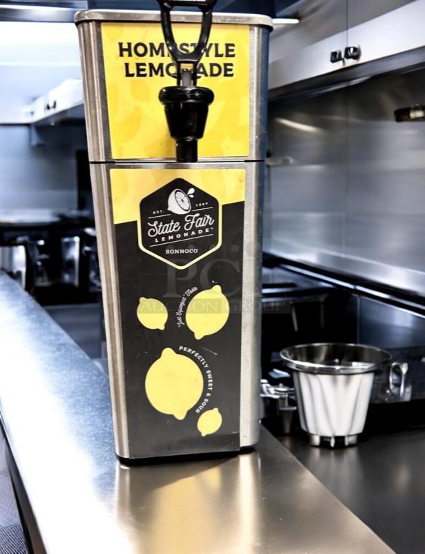 Stainless steel State Fair Lemonade dispenser, model FPM-1 by Newco Enterprises, featuring Ronnoco branding. Brand new.
