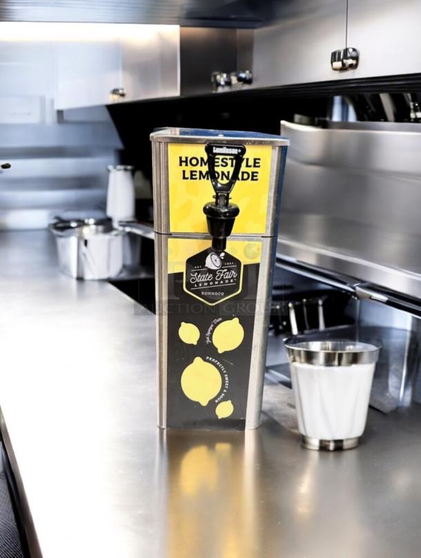 Brand new stainless steel State Fair Lemonade Dispenser, Newco FPM-1, Ronnoco branding, flawless condition.