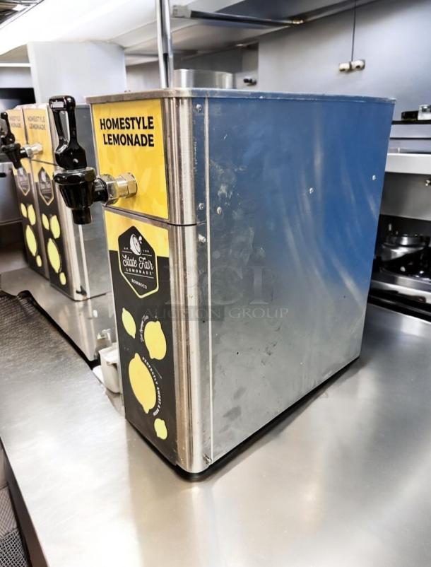 Stainless steel lemonade dispenser, Newco FPM-1, Ronnoco branded, flawless condition, "Homestyle Lemonade" label.