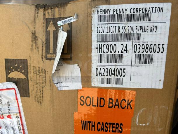 Factory-sealed Henny Penny HHC900.24 full-height heated holding cabinet packaging with visible labels and model details.