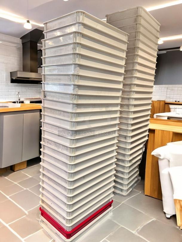 Stacked white plastic dough trays, outstanding condition, high-density food-grade, quantity 50, fully cleaned, stackable.