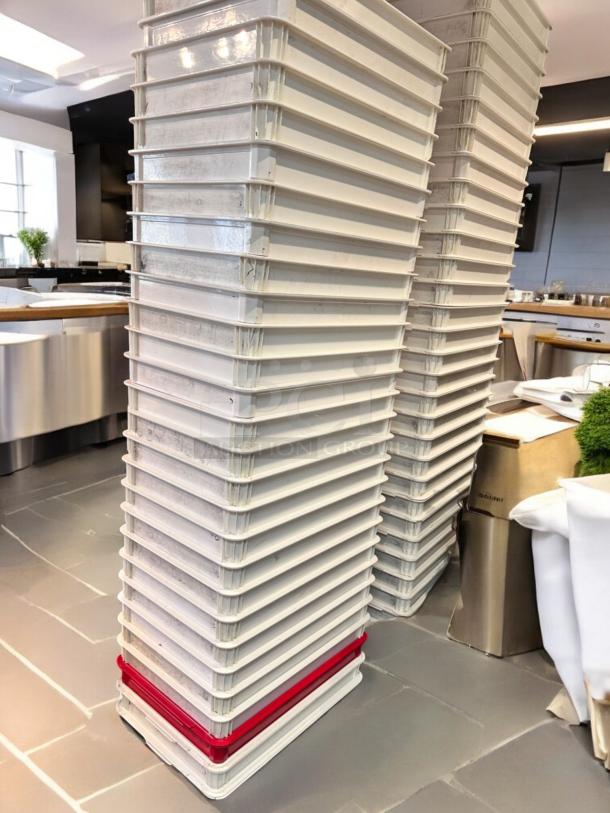 Stack of 50 white stackable commercial dough trays, high-density food-grade plastic, outstanding condition, fully cleaned.