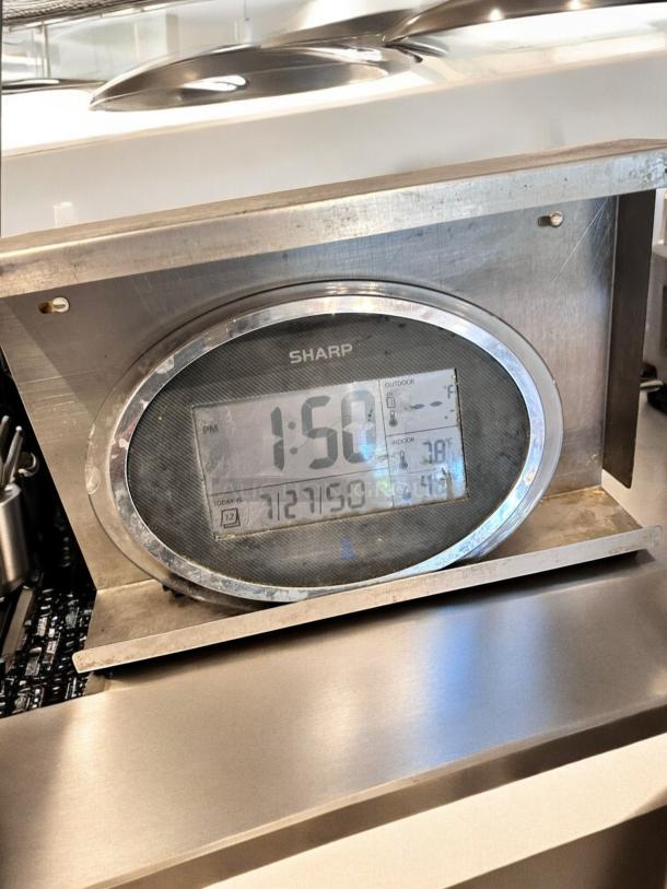 SHARP digital wall clock and thermo-hygrometer with LCD display and stainless steel stand. Displays time, temperature, and humidity. Fully tested.