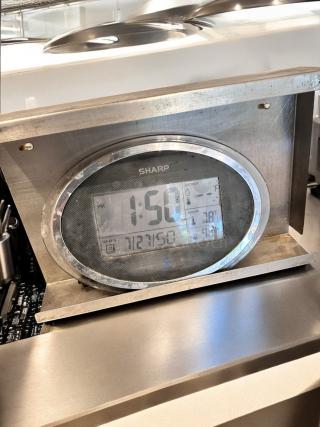 SHARP digital wall clock and thermo-hygrometer with LCD display and stainless steel stand. Displays time, temperature, and humidity. Fully tested.