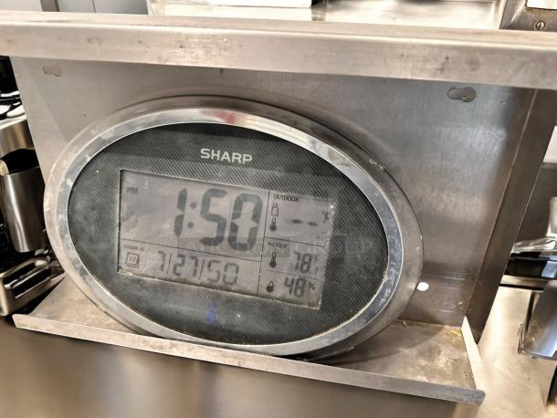 SHARP digital wall clock and thermo-hygrometer in stainless steel stand, displaying time, temperature, and humidity. Fully tested.