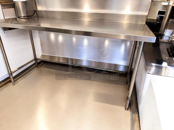 60" stainless steel work table with backsplash, model Custom CCommercial Fabrication, heavy-duty, outstanding condition.