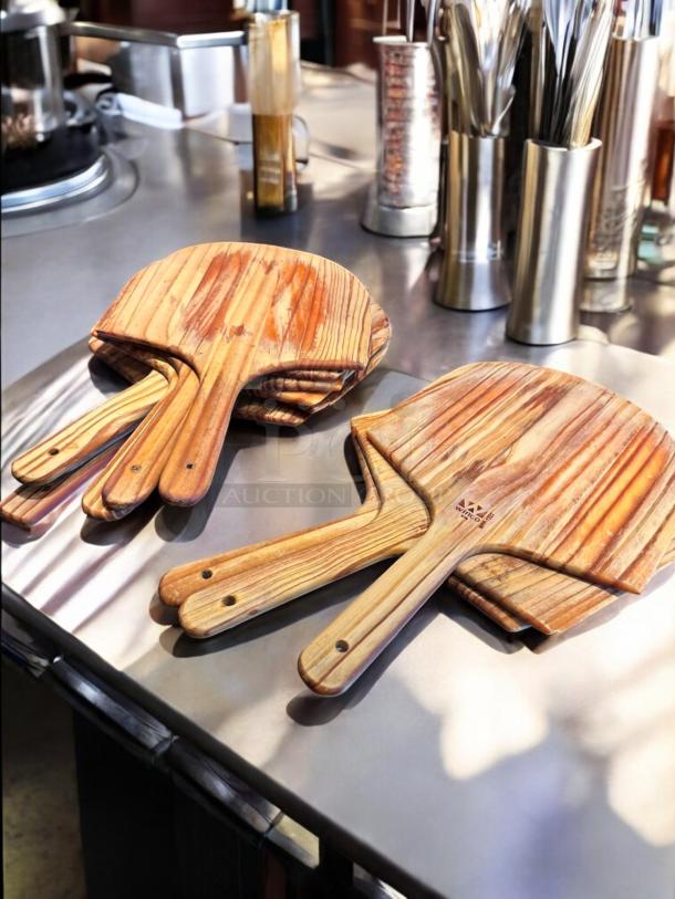 Stack of Winco WPP-1222 wooden pizza peels with 22" blades and 12" handles, premium natural finish, like-new condition.