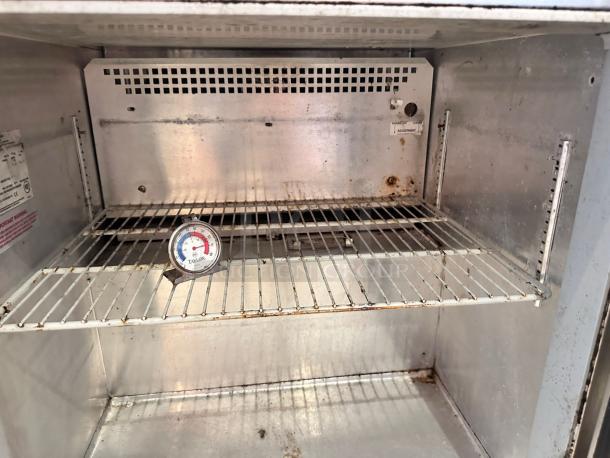 Continental Refrigerator undercounter fridge, 1 solid door, interior view, thermometer on shelf, minor rust marks, tested.