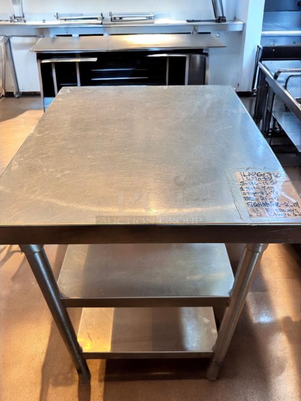 Stainless steel work table with undershelf, 28"x28"x35", like-new, commercial grade, heavy-duty, clean condition.