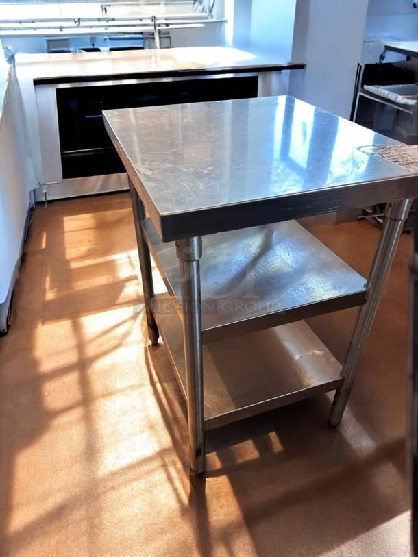 Like-new stainless steel work table, 28"x28"x35", with undershelf. Heavy-duty, commercial grade, fully tested, clean condition.