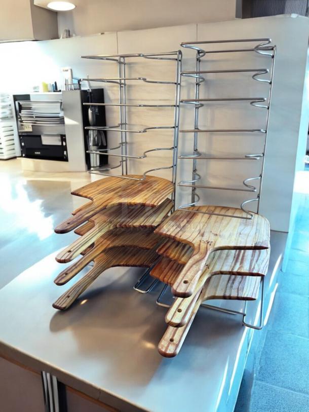 Chrome wire pizza peel rack with 8 wooden paddles, 11"D x 10"W x 28"H, heavy-duty, space-saving design, outstanding condition.