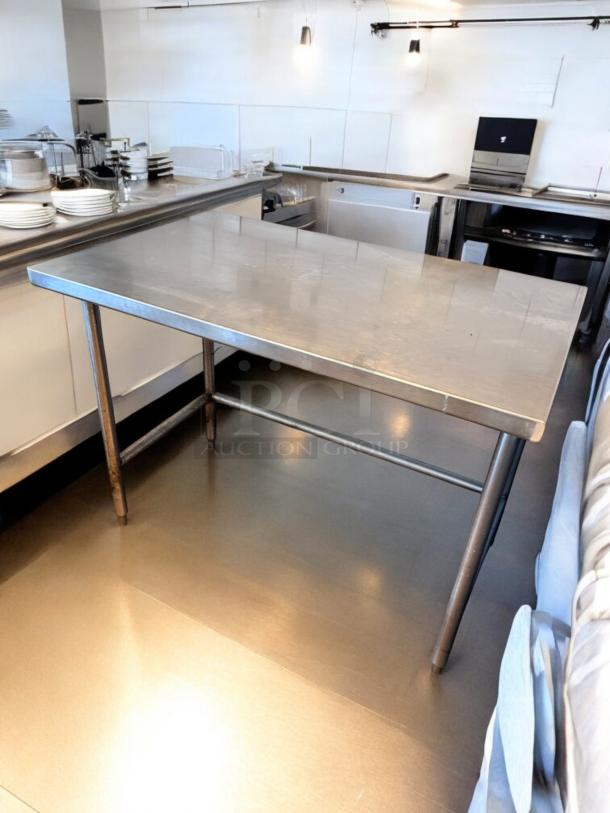Stainless steel work table in like-new condition, 48"x30"x36". Heavy-duty commercial prep table, custom model, ready for use.