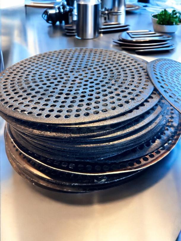 17 pre-seasoned perforated pizza disks, 14" diameter, heavy-duty, superb condition, clean and ready for use.