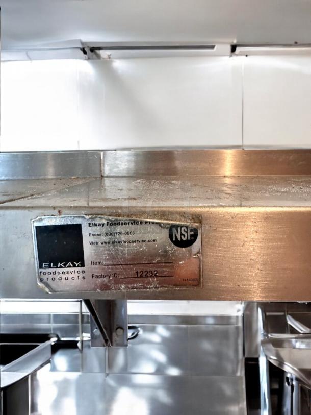 Elkay stainless steel wall shelf, model 12232, 72" width, outstanding condition, NSF certified, label visible.