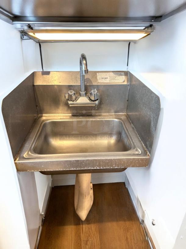 Immaculate Advance Tabco stainless steel hand sink with faucet and side splashes, wall mount design, fully tested.