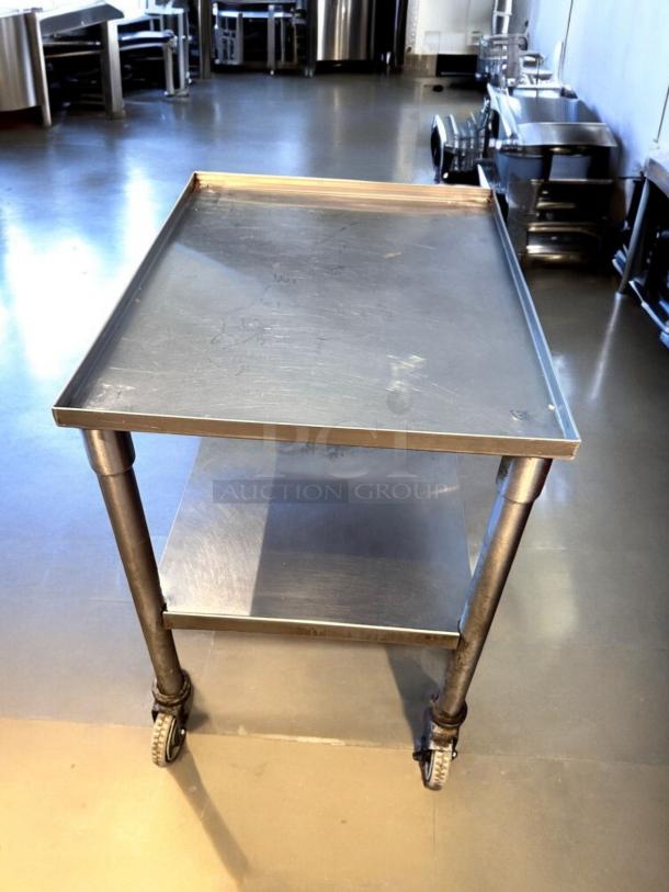 Top-tier stainless steel utility prep cart, 23"x18"x34.5", on casters, fully tested and working, excellent condition.