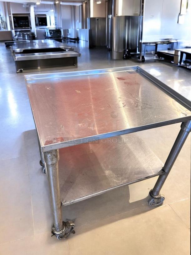Stainless steel utility prep cart on casters, 23"x18"x34.5". Top-tier condition, fully tested, with two shelves.