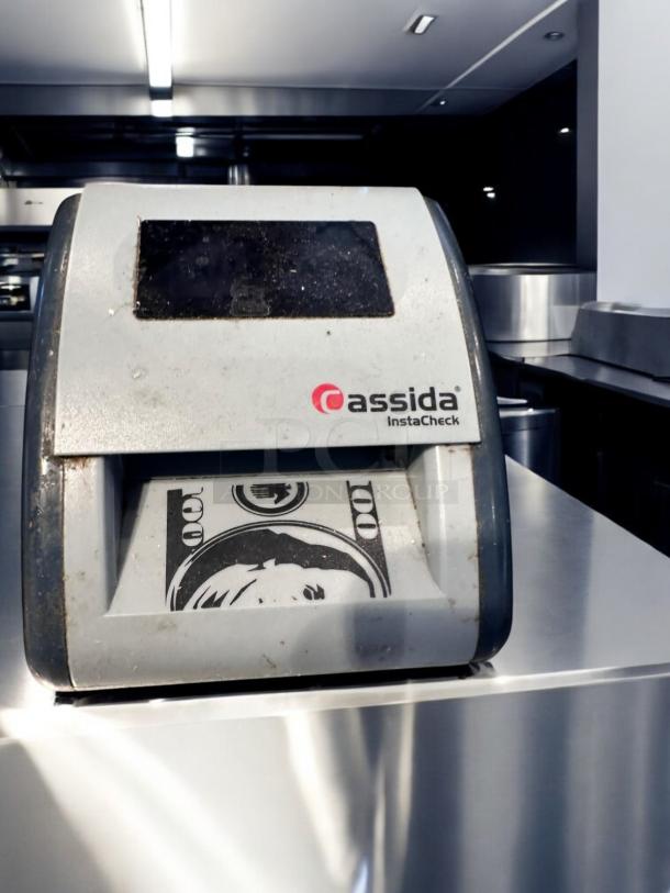 Cassida InstaCheck automatic currency detector, superb condition, fully tested. Visible logo and currency display on front.