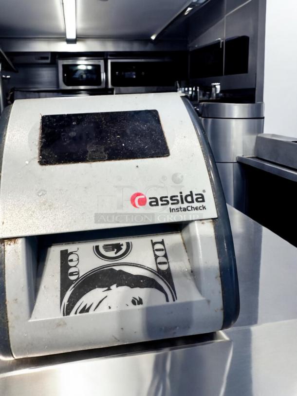 Cassida InstaCheck automatic currency detector in superb condition, fully tested and working, showing dollar bill image.